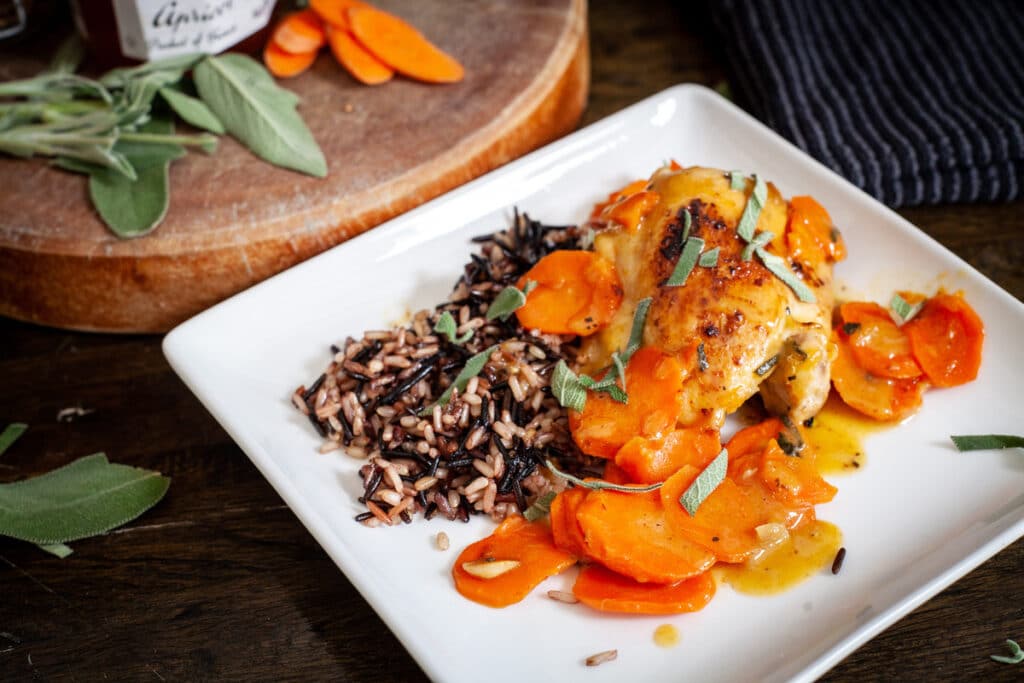 Apricot chicken with sage and wild rice on a plate