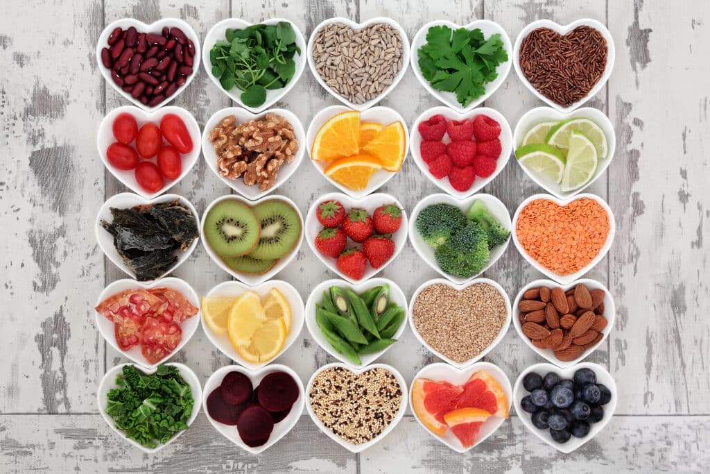 A selection of fresh whole foods arranged in heart-shaped bowls