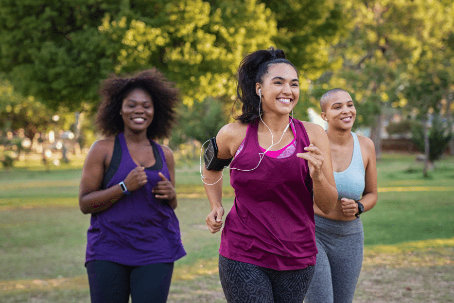 Three women walking together outdoors in a park